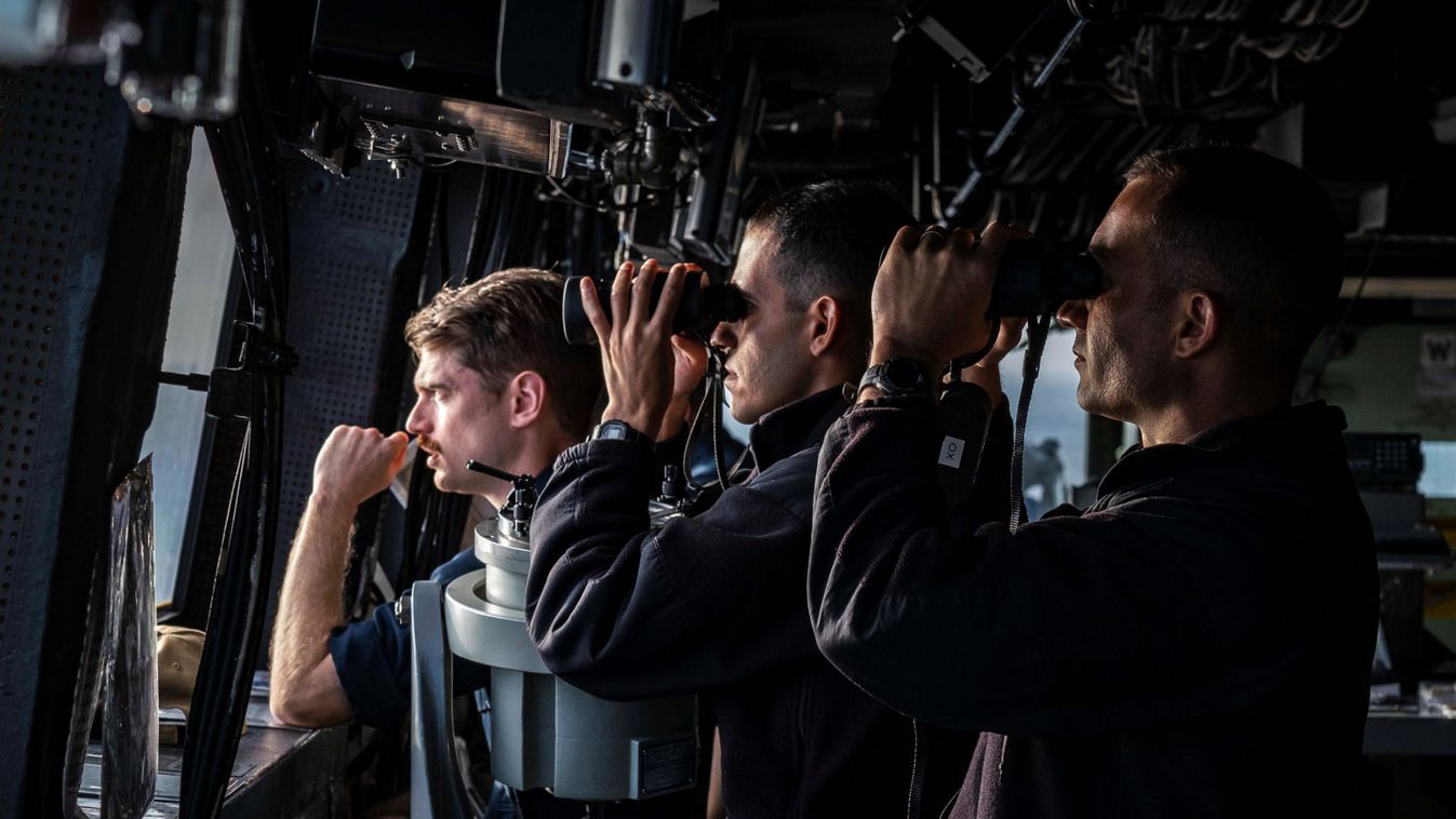Officers stand bridge watch aboard USS Green Bay in the Taiwan Strait