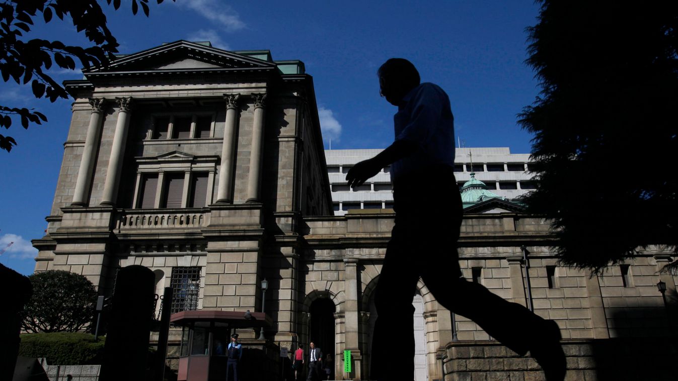 A man walks past the Bank of Japan headquarters building in Tokyo