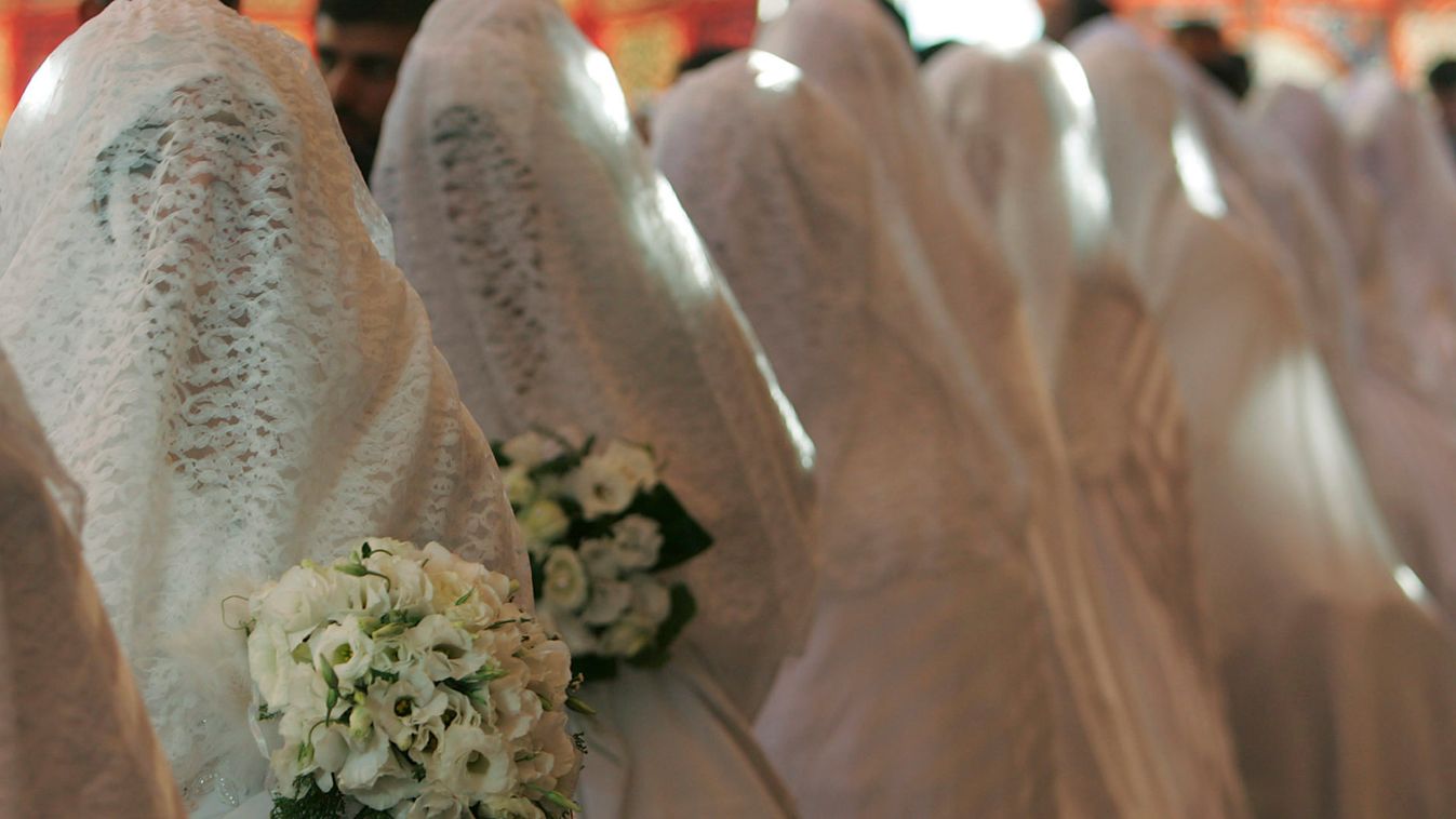 Jordanian grooms and brides take part in a mass wedding ceremony in Amman