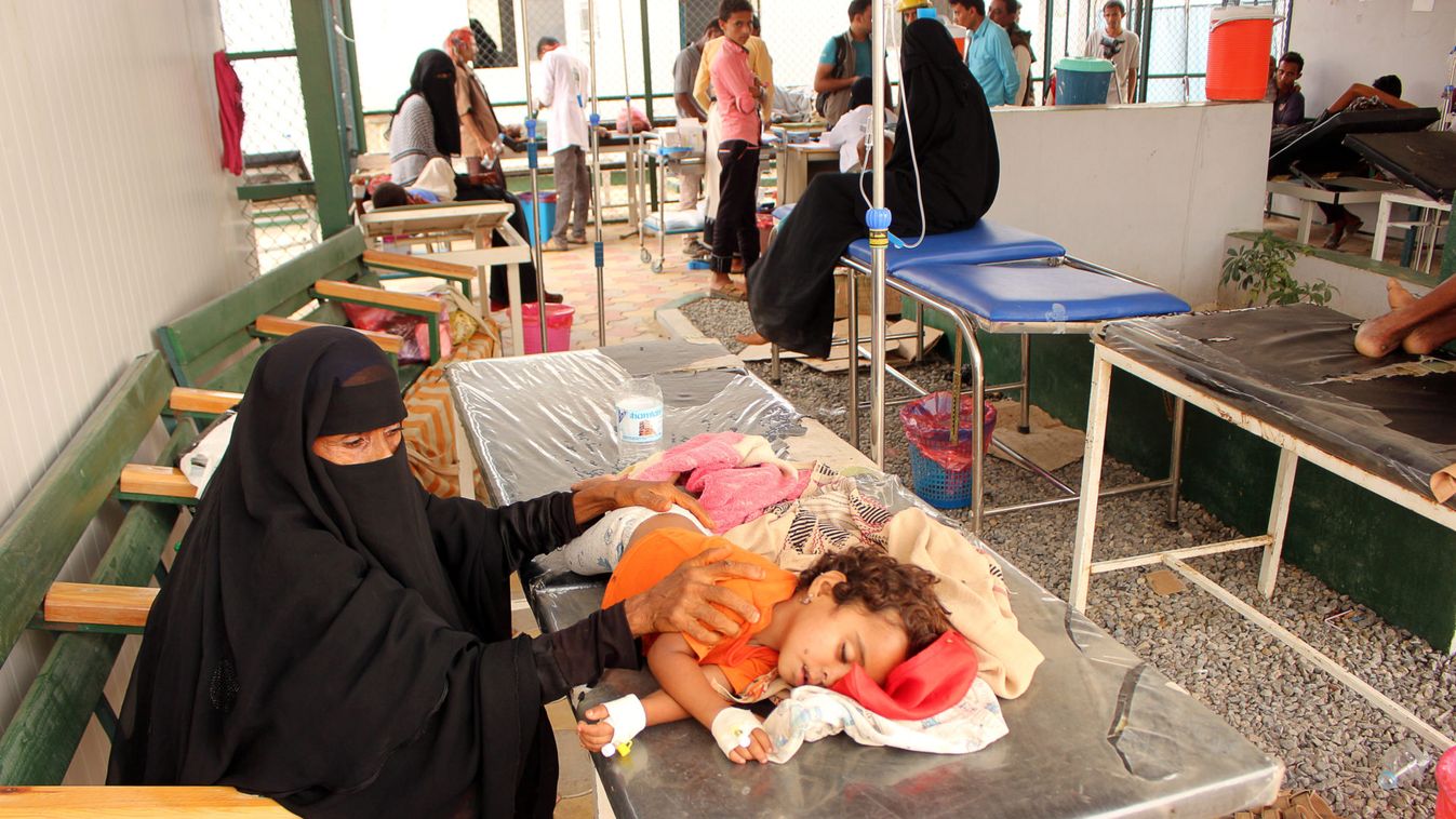 A girl, cholera patient, lies on a bed as she receives medical care at a health center in the village of Islim, in the northwestern province of Hajjah