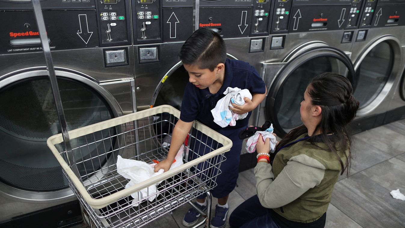 Yuritzy Quinones, 29, does laundry with her son, True Garcia, 8, in Los Angeles