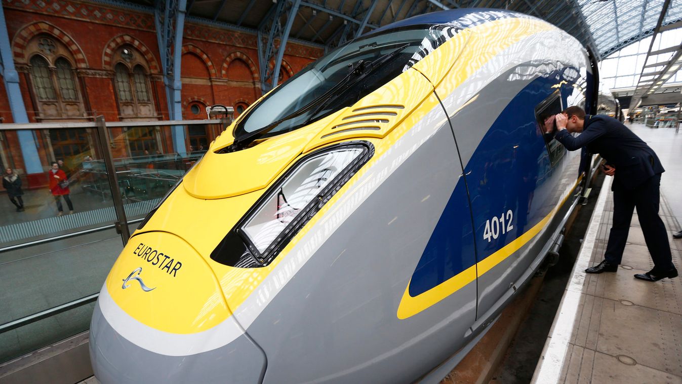 A Eurostar employee peers into the driver's cab of their new Siemens e320 train at St Pancras station in central London