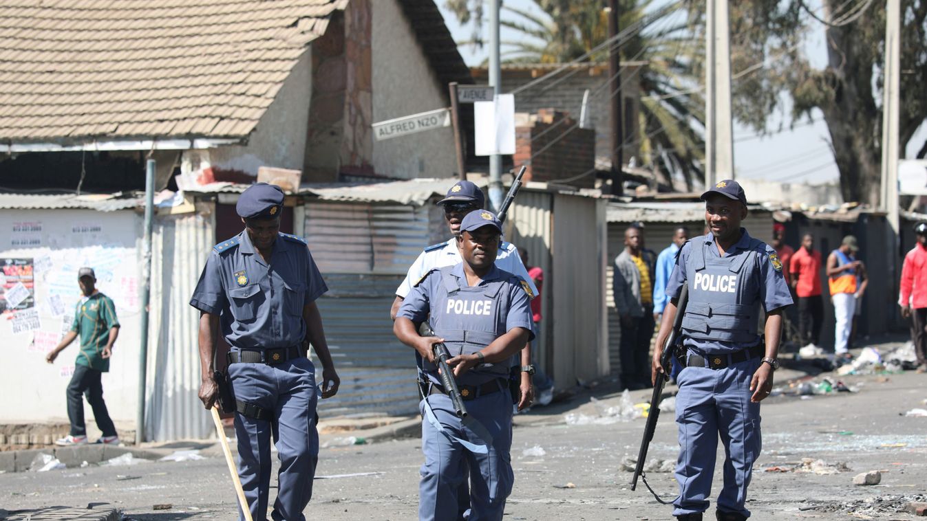 Police patrol the streets after overnight unrest and looting in Alexandra township, Johannesburg