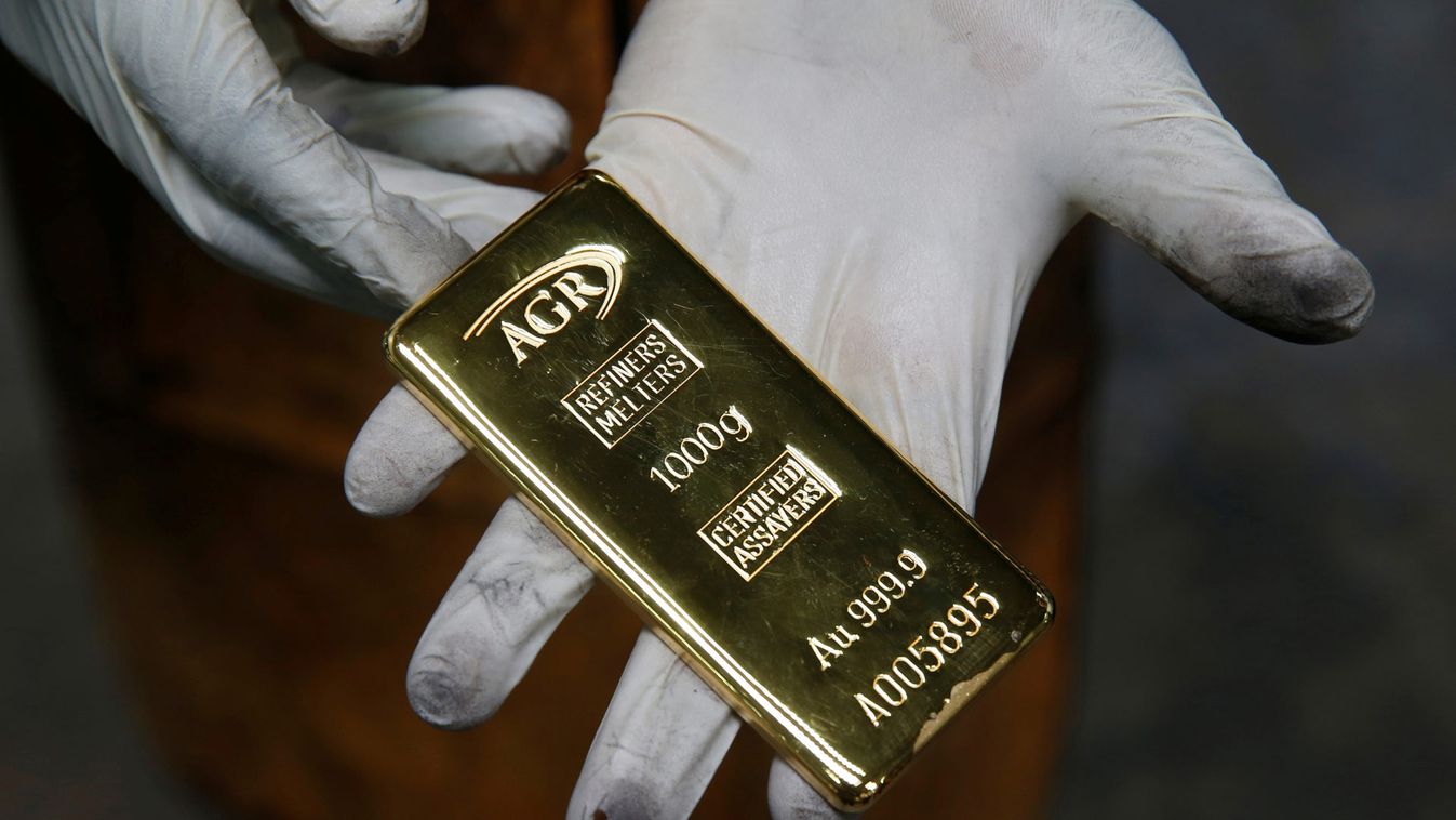An employee holds a 1kg gold bar at AGR (African Gold Refinery) in Entebbe