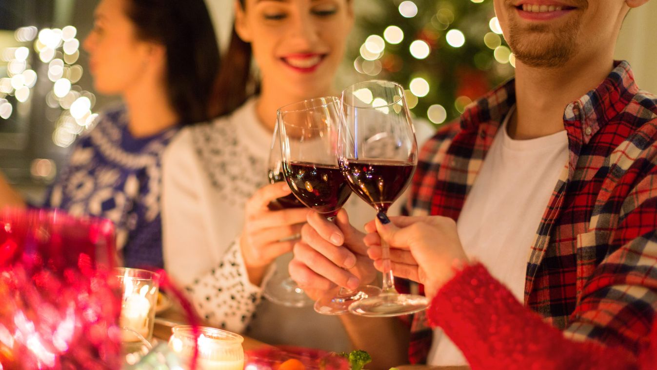 close up of friends with wine celebrate christmas