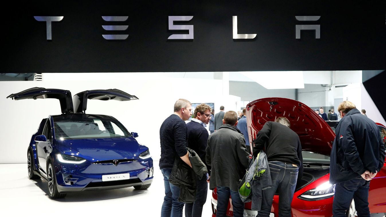 Visitors inspect Tesla electric cars at Brussels Motor Show