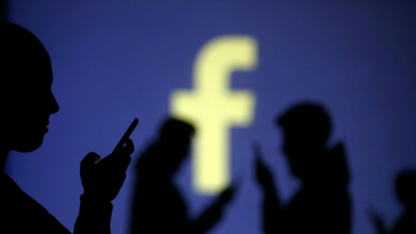Silhouettes of mobile users are seen next to a screen projection of Facebook logo in this picture illustration
