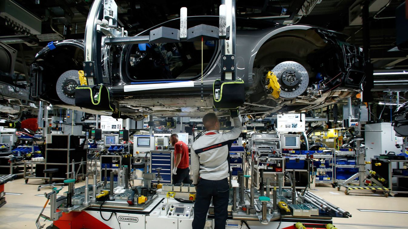 An employee of German car manufacturer Porsche works on a Porsche sports car at the Porsche factory in Stuttgart-Zuffenhausen