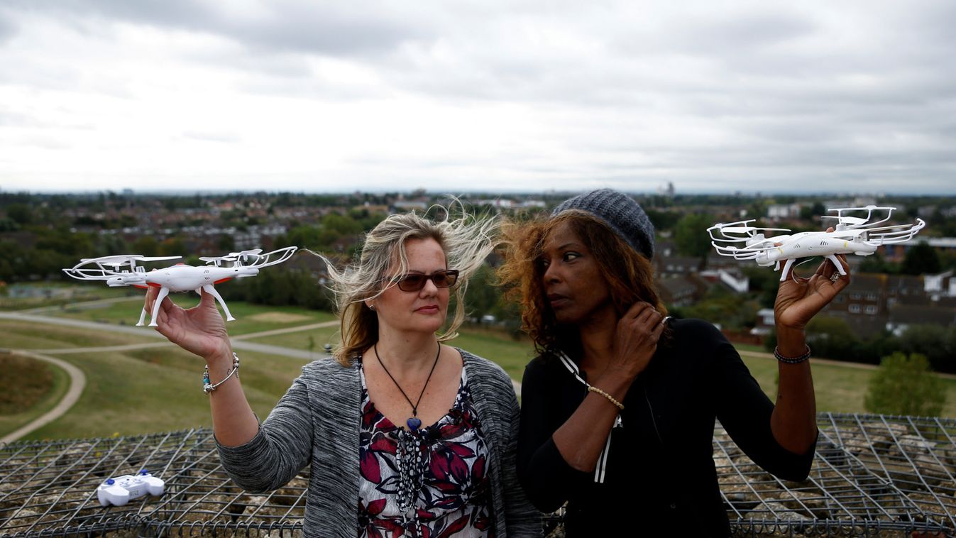 Activists Valerie Milner-Brown and Linda Davidsen pose with drones near Heathrow Airport in London