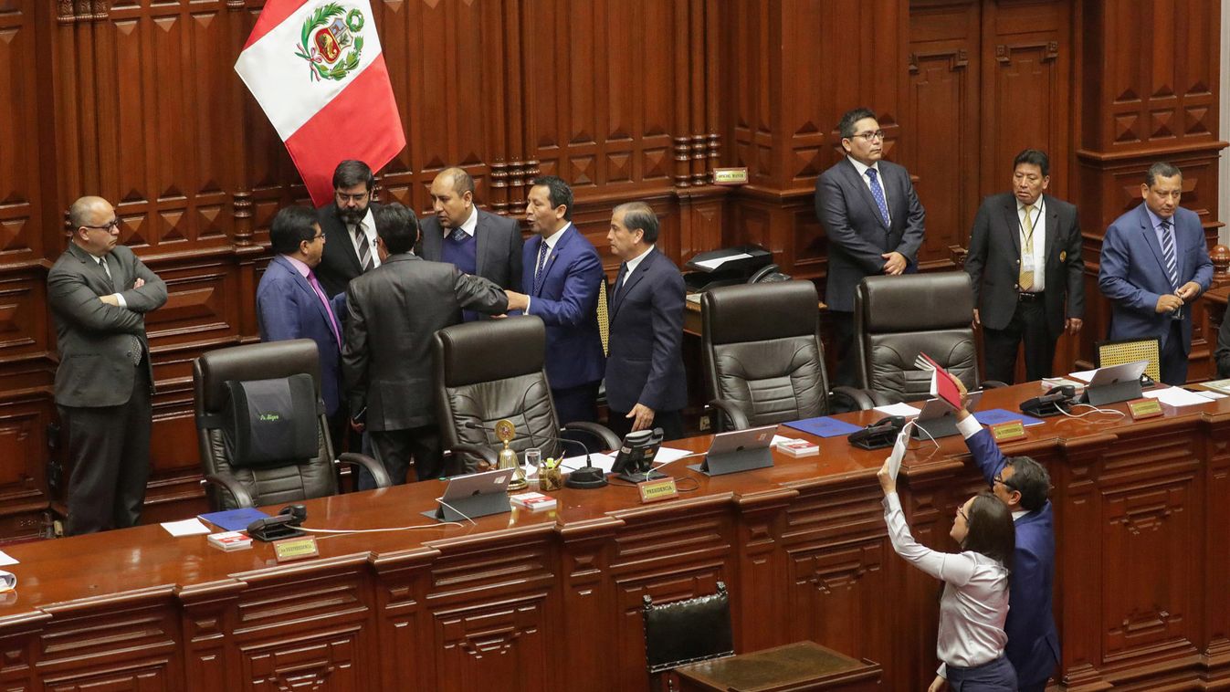 Peruvian lawmakers react during a session at Congress in Lima