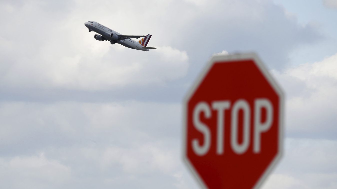A Germanwings airplane flies past a stop sign during take-off from Duesseldorf airport 