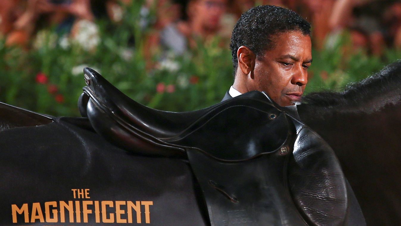 Actor Denzel Washington poses next to a horse during the red carpet of the movie "The Magnificent Seven" at the 73rd Venice Film Festival in Venice