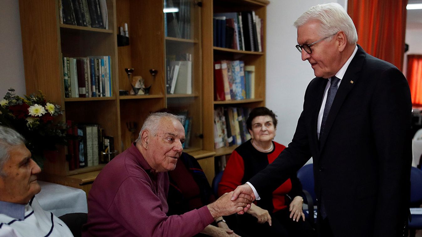 German President Frank-Walter Steinmeier shakes hands with a man during his meeting with a group of people, including Holocaust survivors, at AMCHA, an organisation providing support to Holocaust survivors in Israel, in Jerusalem