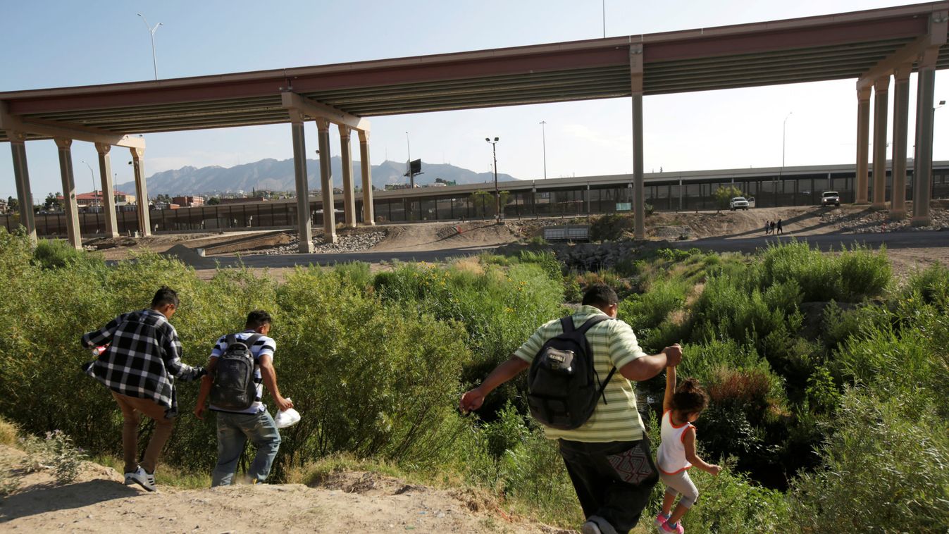 Migrants are seen at the banks of the Rio Bravo crossing illegally to the United States to turn themselves in to request asylum in El Paso, Texas, U.S., as seen from Ciudad Juarez