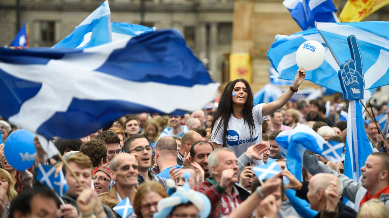 Campaigners wave Scottish Saltires at a 'Yes' campaign rally in Glasgow