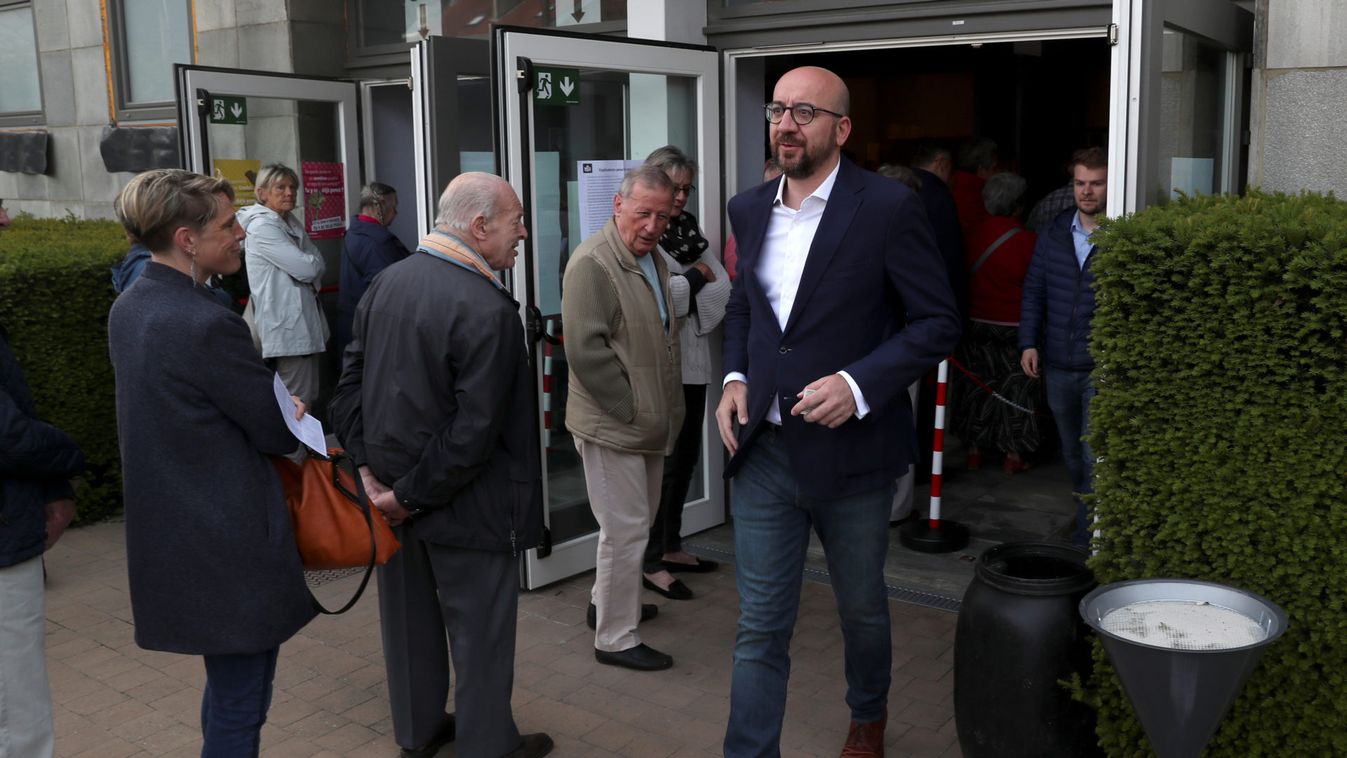 Belgian Prime Minister Charles Michel leaves after casting his vote for the Belgian general and regional elections and for the European Parliament Elections in Limal