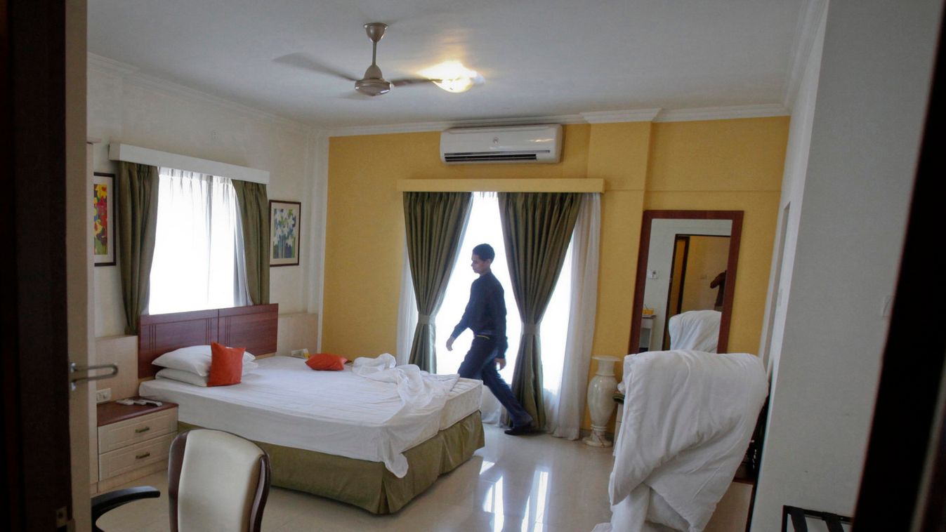 A member of the housekeeping staff prepares a room at the Keys Hotel Nestor in Mumbai