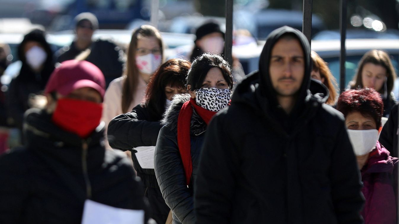 People wearing face masks in attempt to prevent the spread of coronavirus disease (COVID-19) wait outside a labour office in Sofia