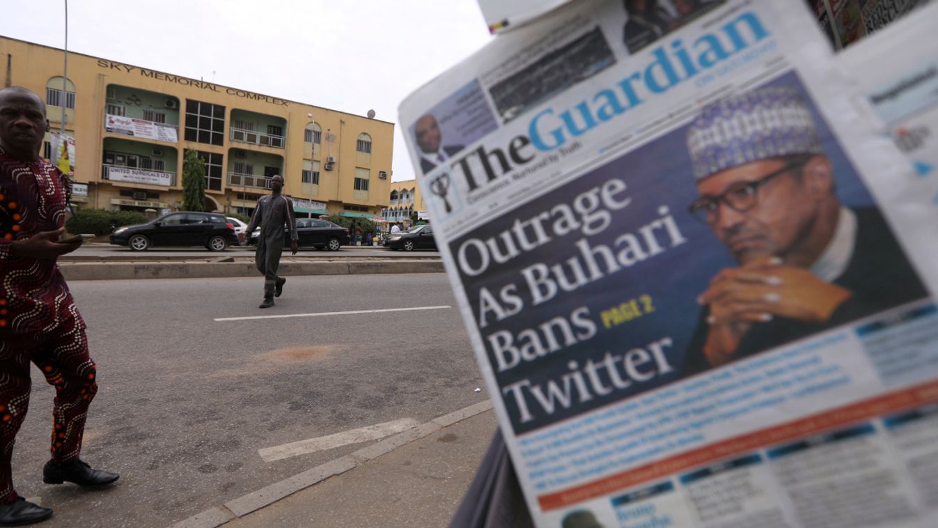 Man looks at newspapers at a newsstand in Abuja
