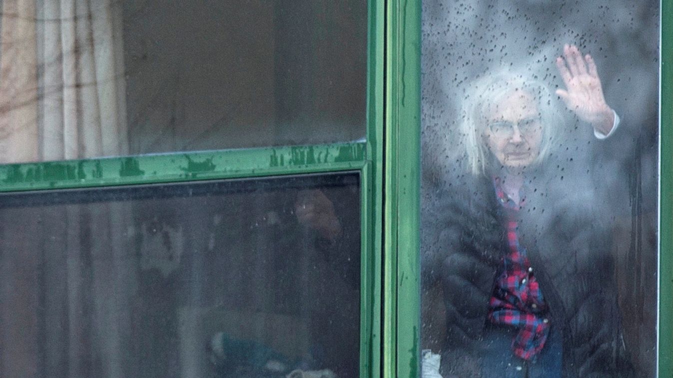 A resident waves from her window at a senior's long-term care facility during the coronavirus disease (COVID-19) outbreak, in Montreal