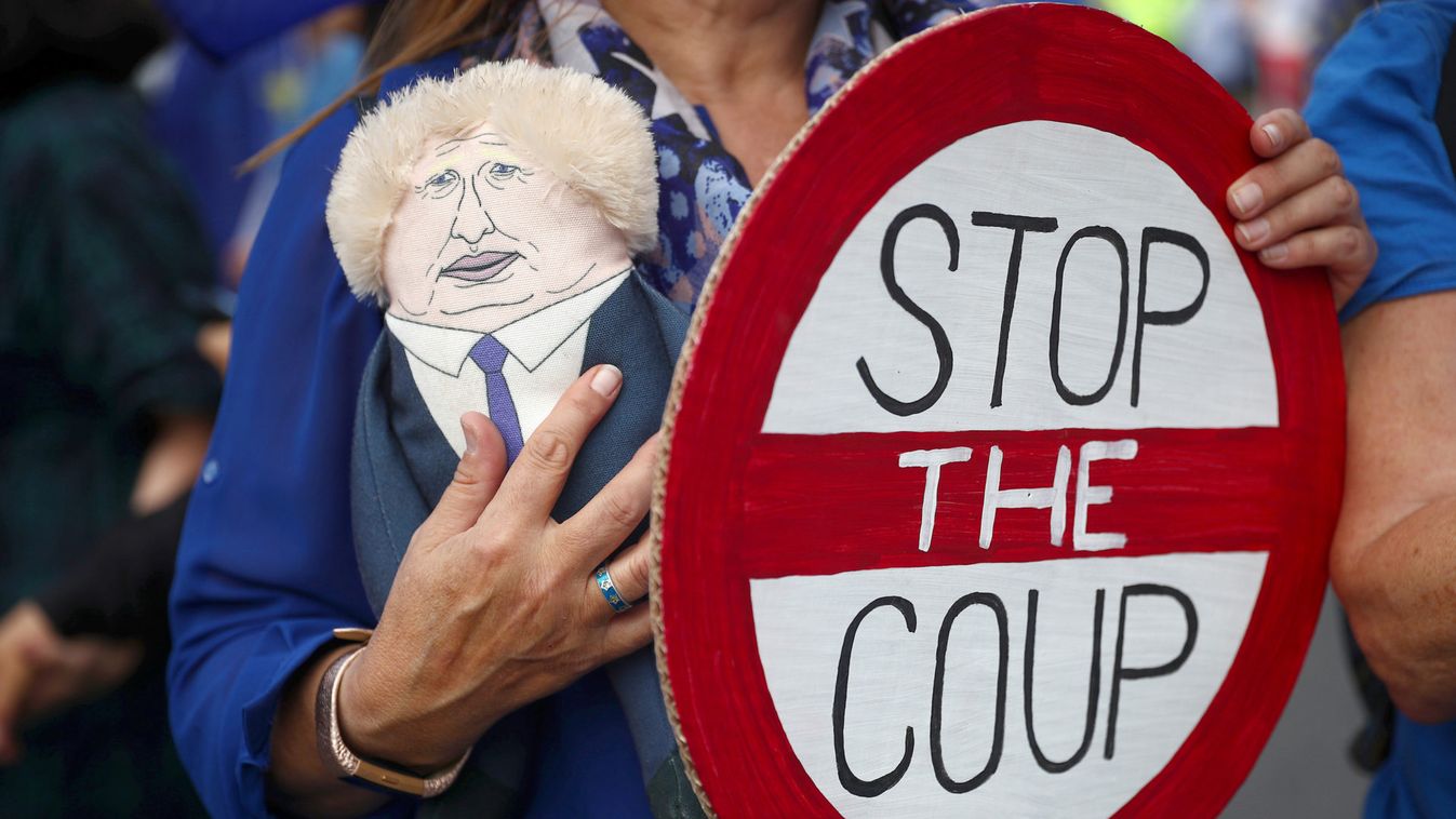 An anti-Brexit protester holds a puppet and a sign during a demonstration at Westminster, in London