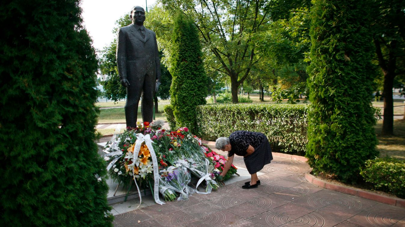 A woman places flowers in front of the monument of Bulgaria's late communist dictator Todor Zhivkov in Pravets