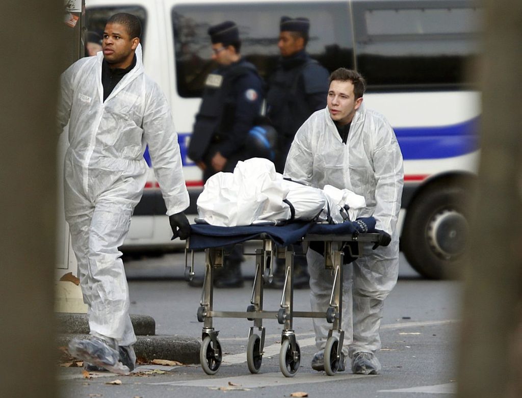 A victim is wheeled out of the Bataclan concert hall the morning after a series of deadly attacks in Paris