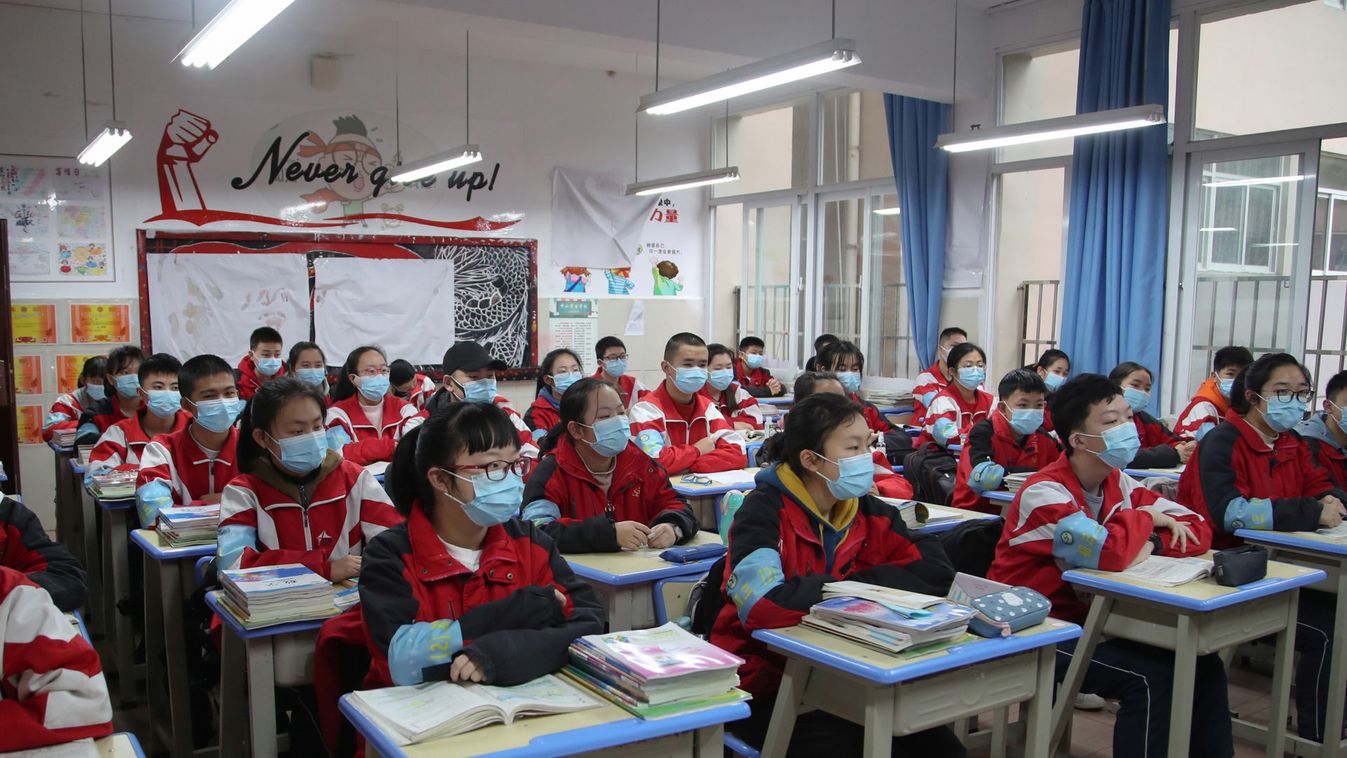 Junior high students wearing face masks attend a class on their first day of returning to school following an outbreak of the novel coronavirus, in Guiyang, Guizhou