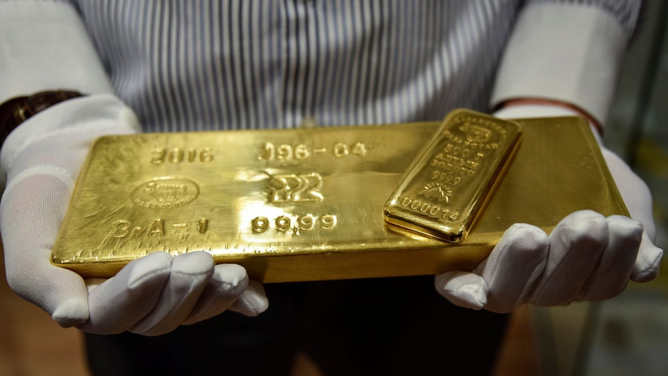 An employee holds gold bars in the Kazakhstan's National Bank vault in Almaty