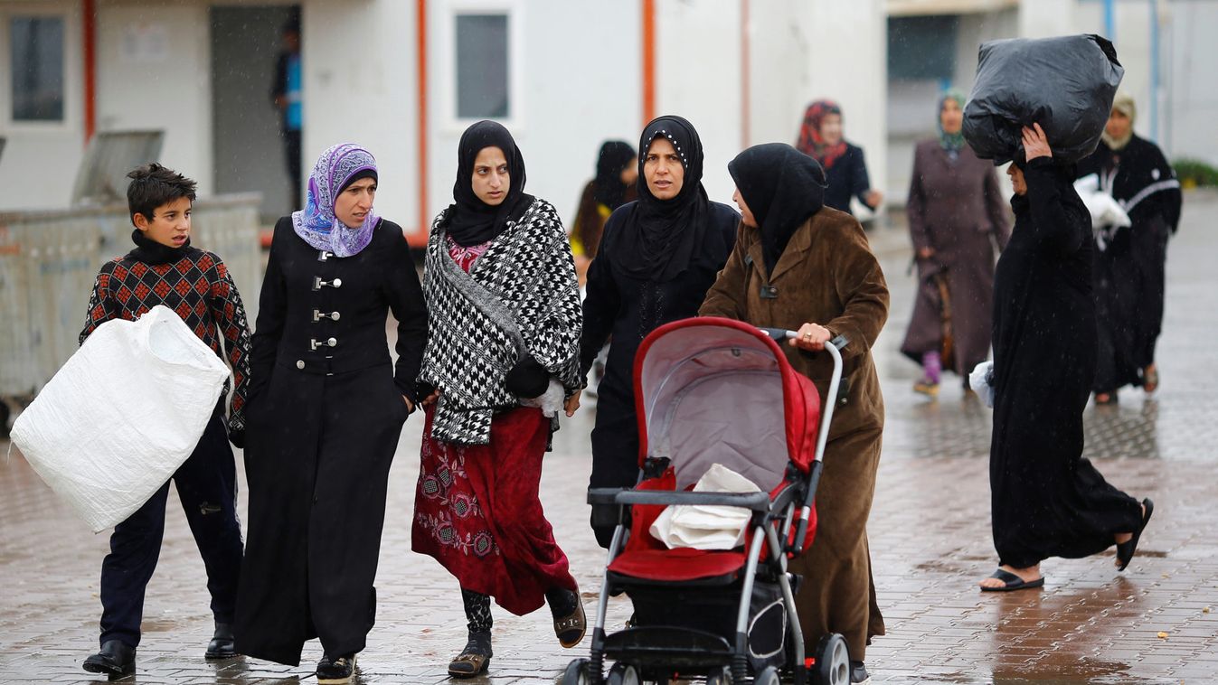 Syrian refugee women walk in Elbeyli refugee camp near the Turkish-Syrian border in Kilis province