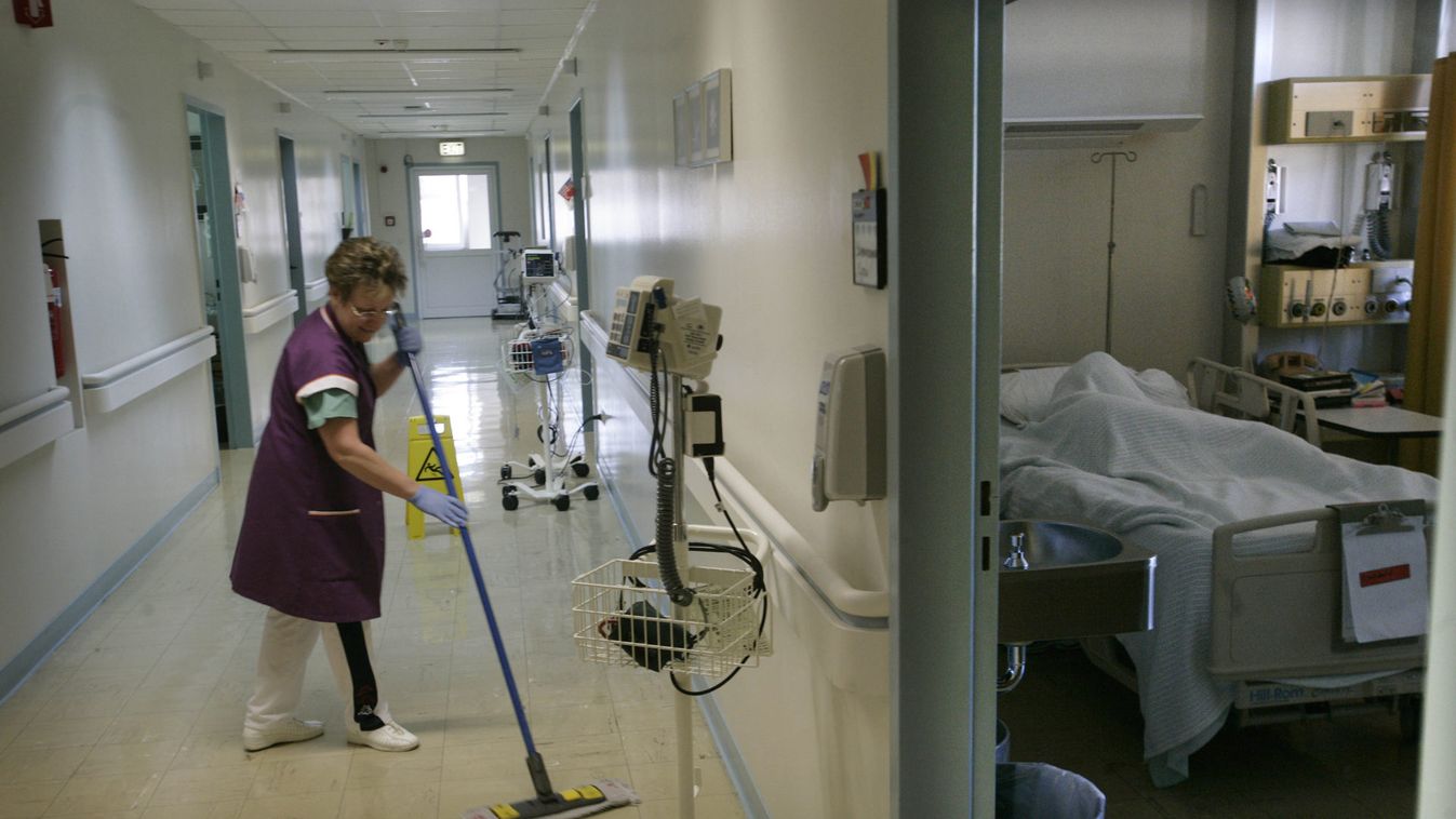 A cleaning woman cleans the doorway inside the  Landstuhl Regional Medical Centre