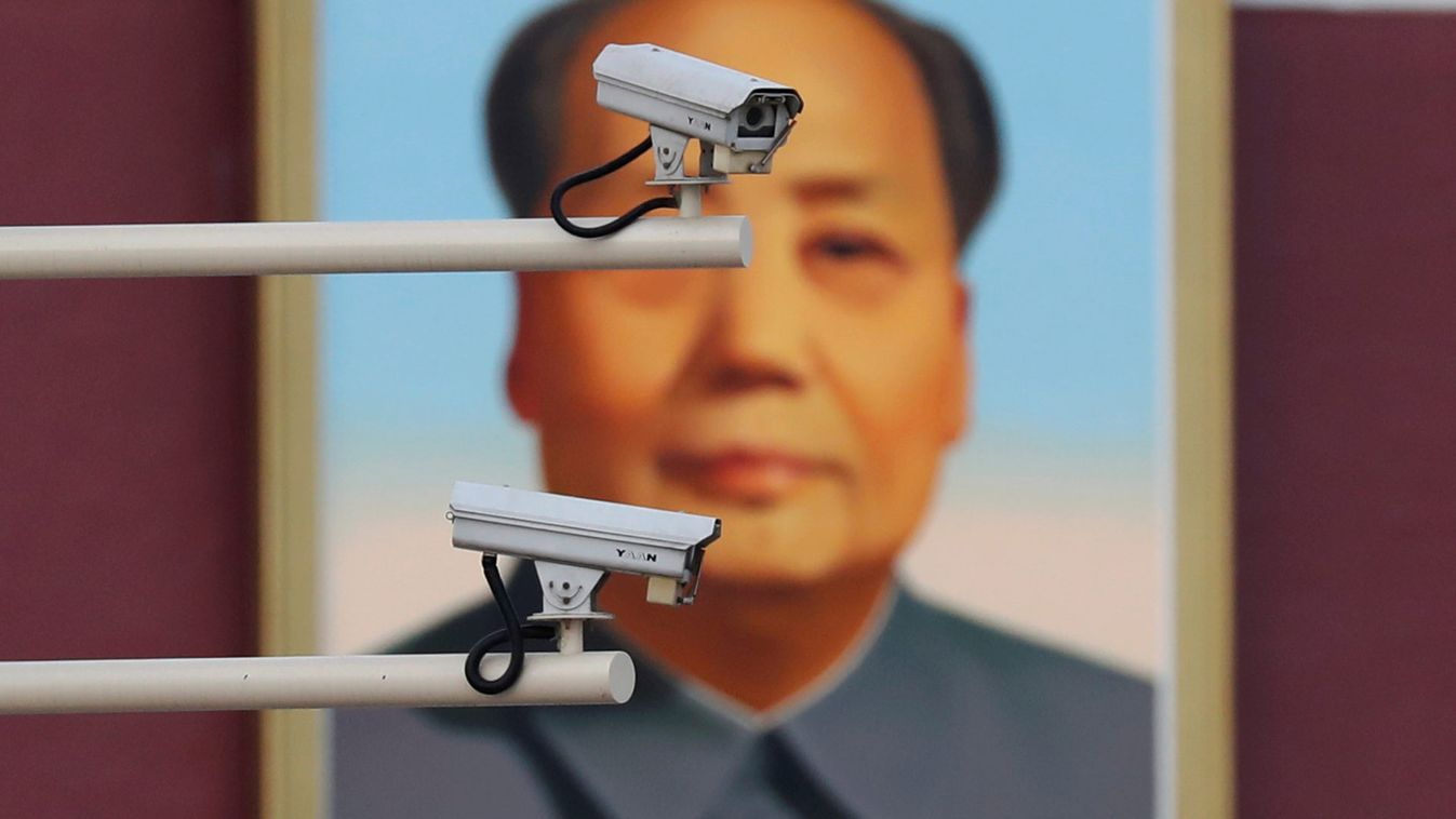 Security cameras are seen in front of a portrait of late Chinese Chairman Mao at the Tiananmen gate in Beijing