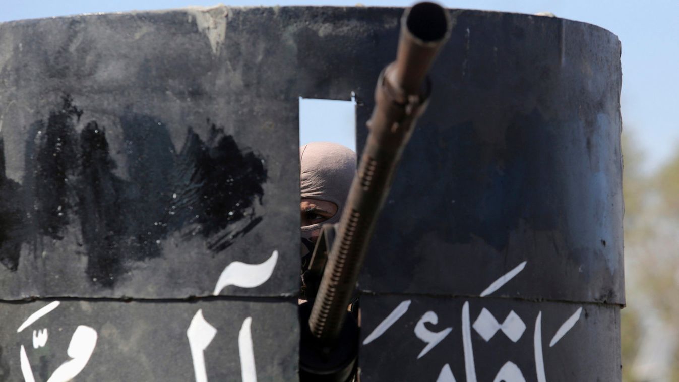 A Shi'ite fighter rides a military vehicle while guarding on the outskirts of Diyala province, north of Baghdad