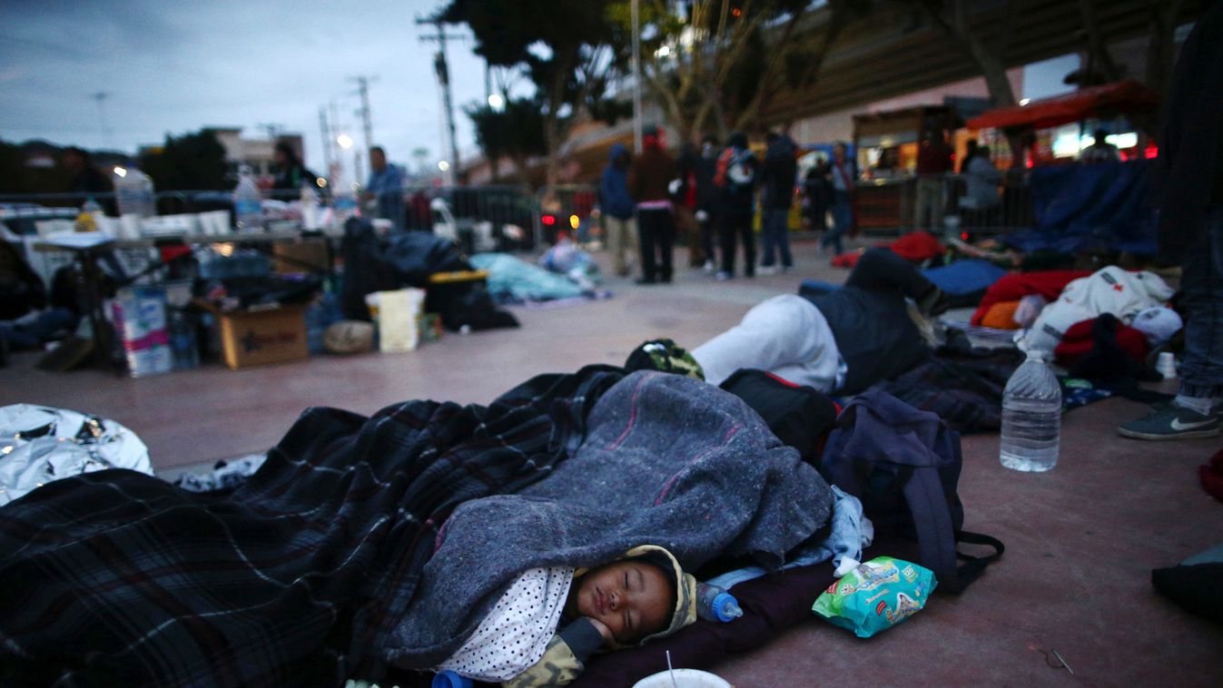 Members of a caravan of migrants from Central America sleep near the San Ysidro checkpoint after a small group of fellow migrants entered the United States border and customs facility, where they are expected to apply for asylum, in Tijuana