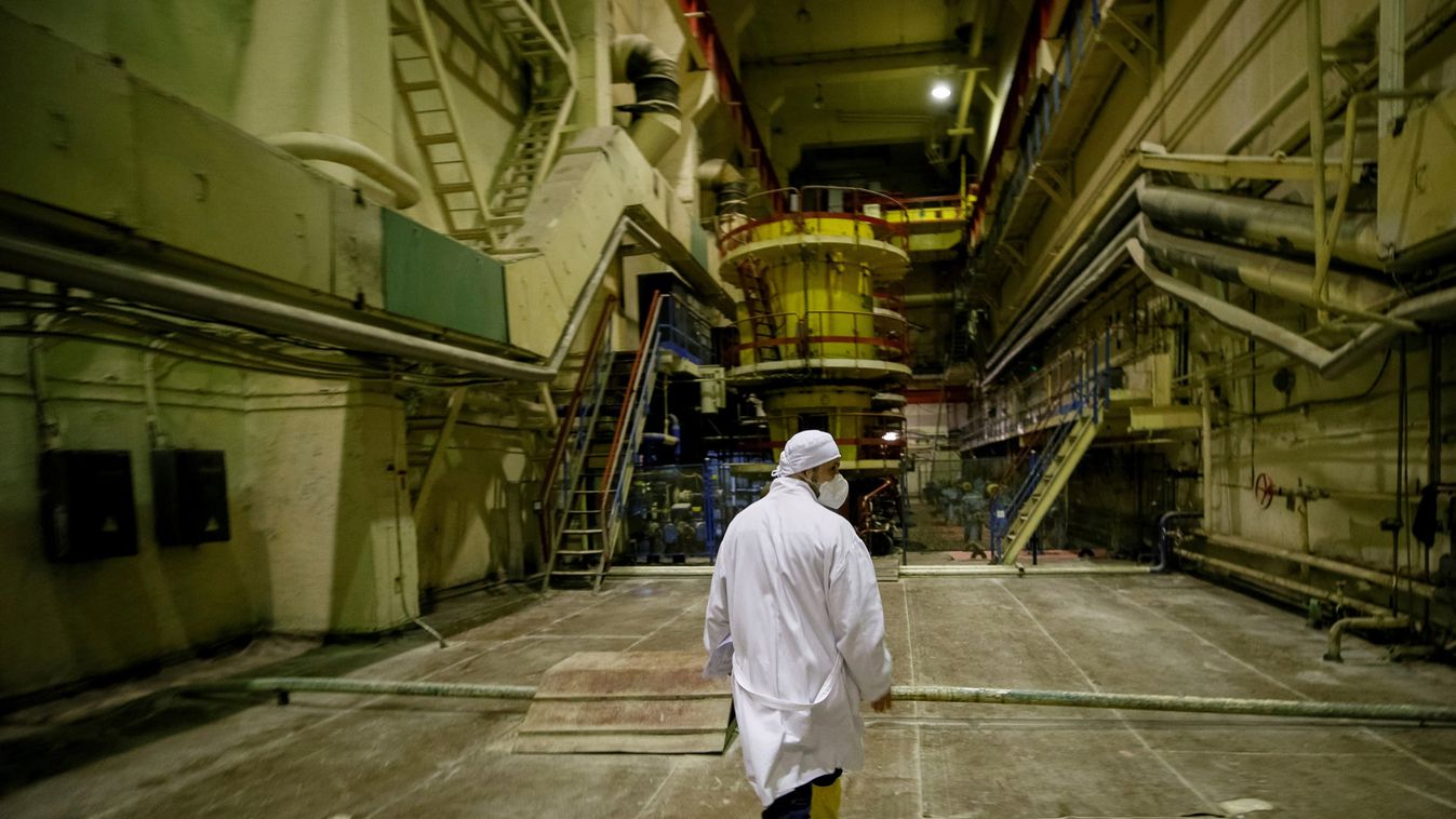 An employee walks through a pump room of  the stopped third reactor at the Chernobyl nuclear power plant in Chernobyl
