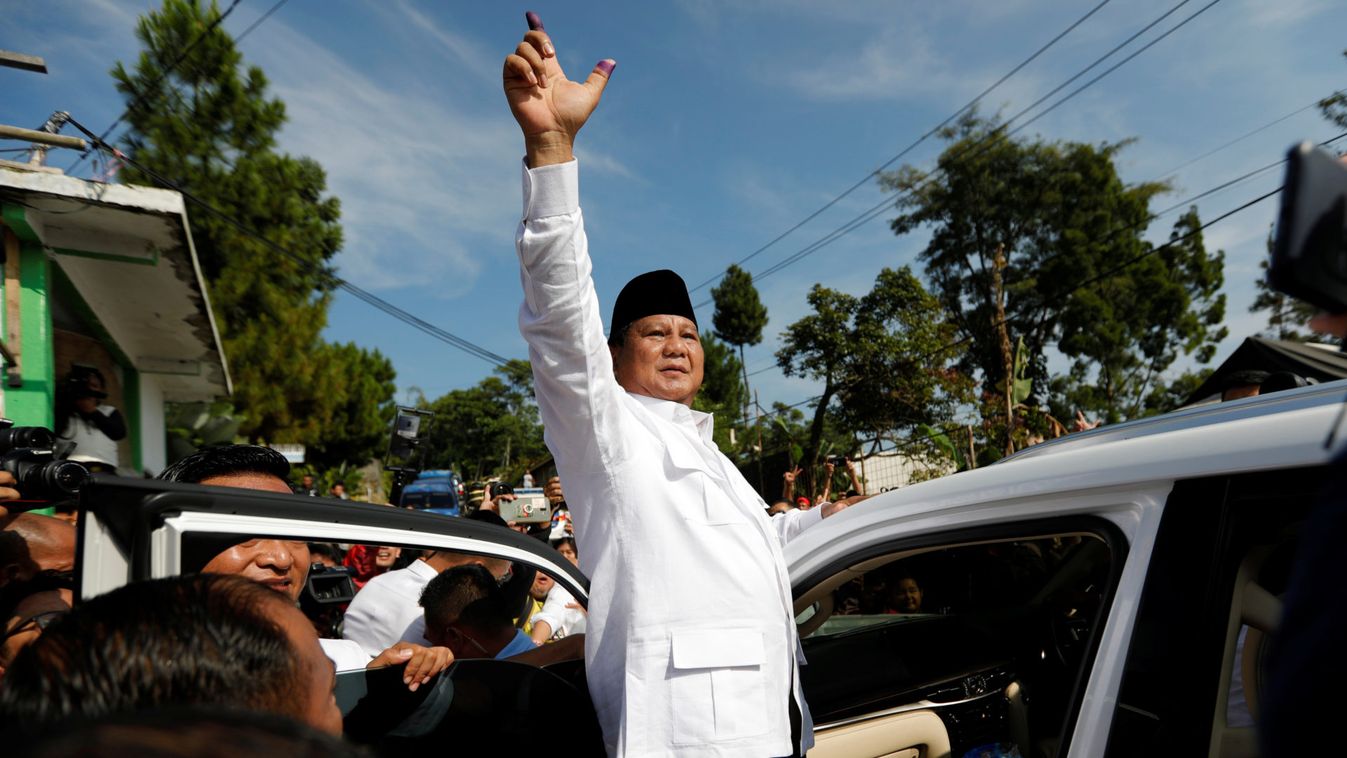 Indonesian presidential candidate Prabowo Subianto shows his ink-stained finger after voting at a polling booth during elections in Bogor