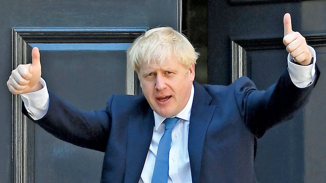 Boris Johnson gestures as he arrives at the Conservative Party headquarters in London
