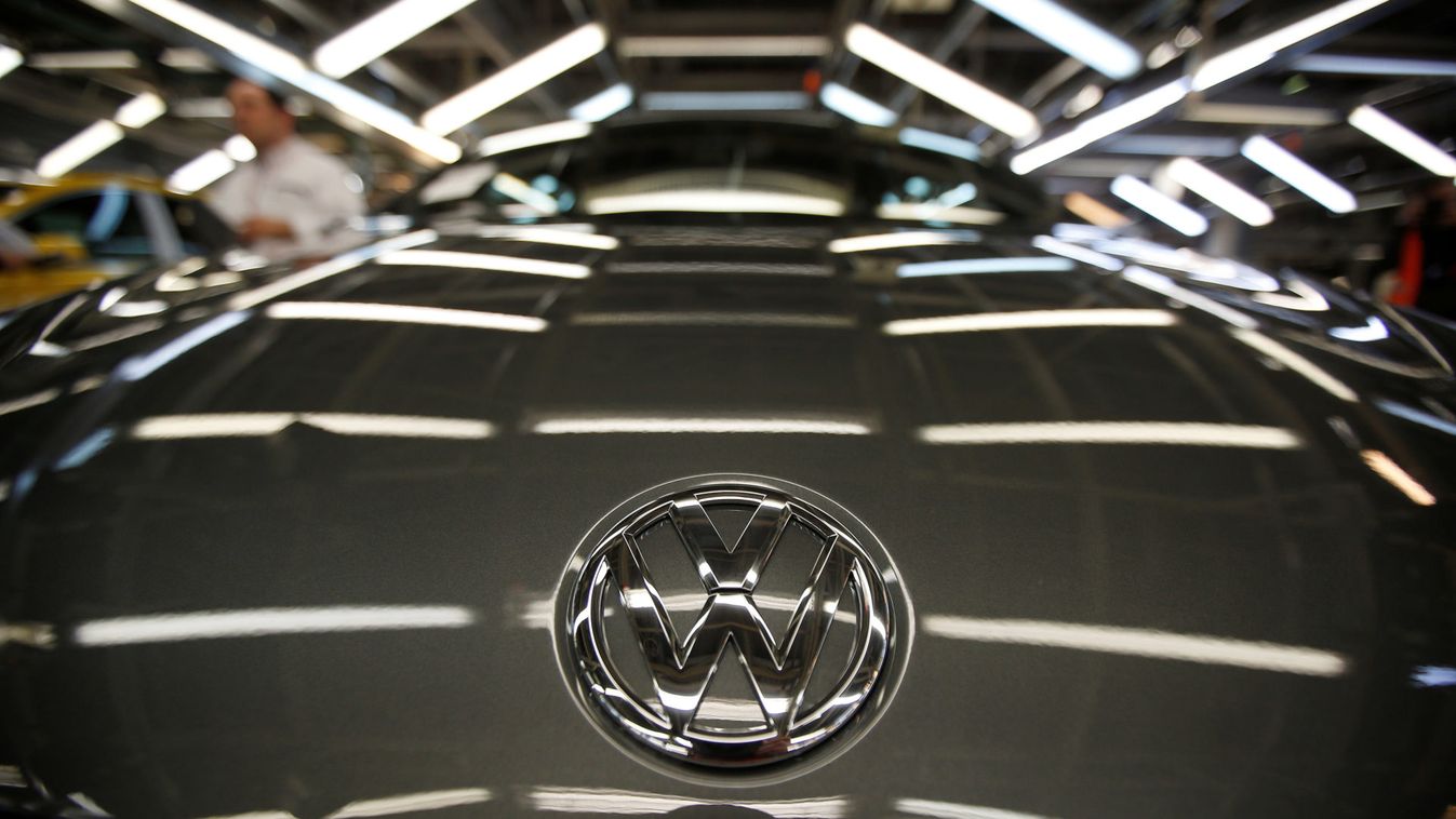 The logo of Volkswagen company is seen on a car on an assembly line at the Volkswagen car factory in Palmela