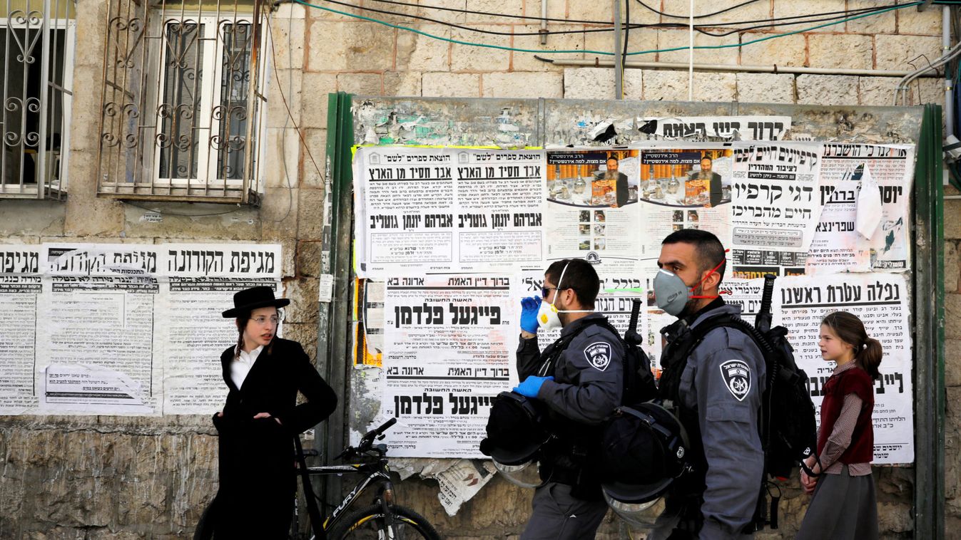 Israeli policemen walk down a street as they enforce government restrictions to fight the spread of the coronavirus disease (COVID-19) in the ultra-Orthodox Jewish neighborhood of Mea Shearim in Jerusalem