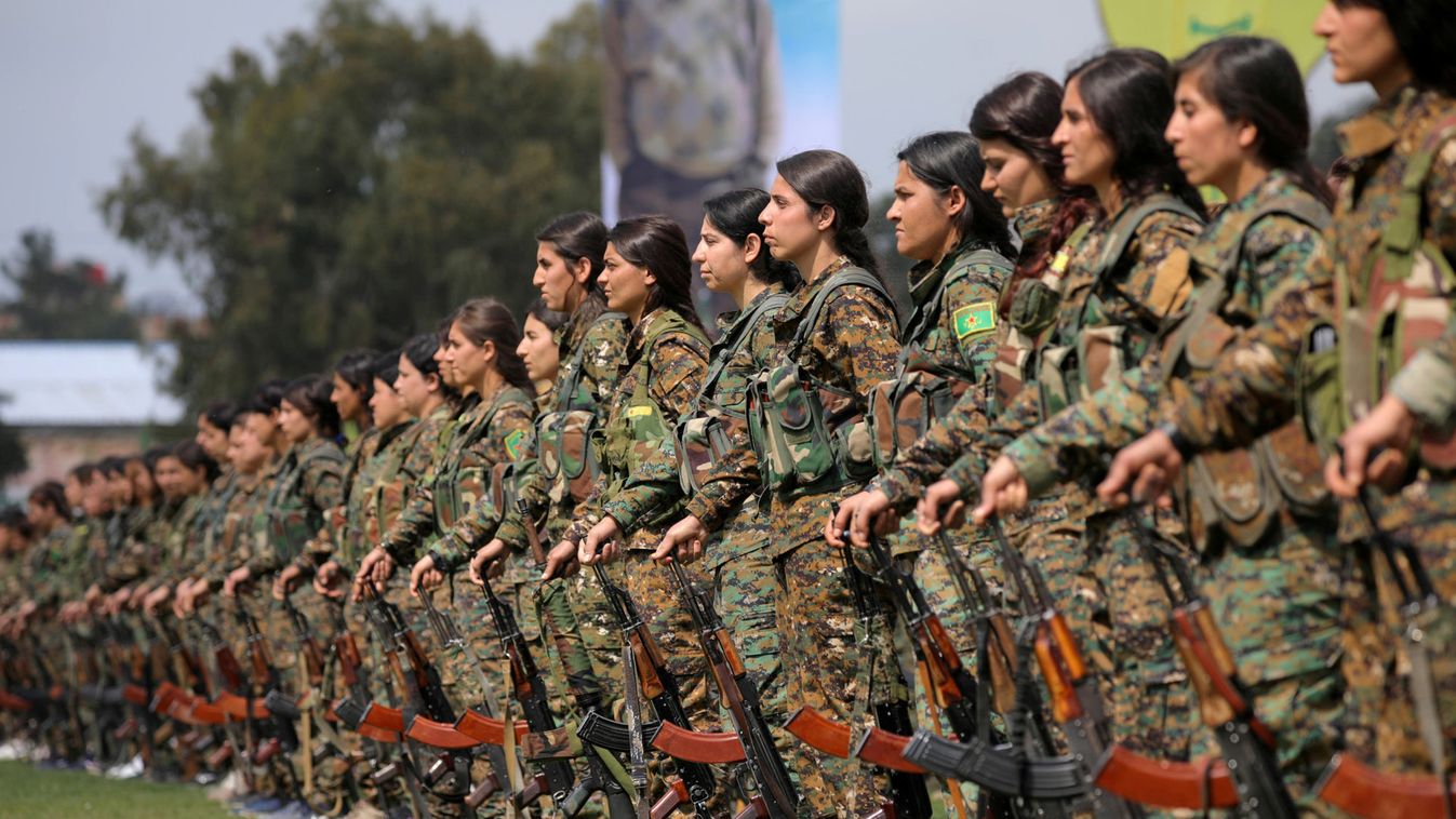 Kurdish female fighters of the Women's Protection Unit (YPJ) take part in a military parade as they celebrate victory over the Islamic state, in Qamishli