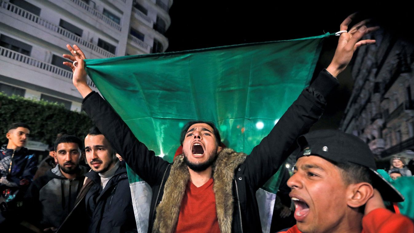 People celebrate on the streets after President Abdelaziz Bouteflika announced he will not run for a fifth term, in Algiers