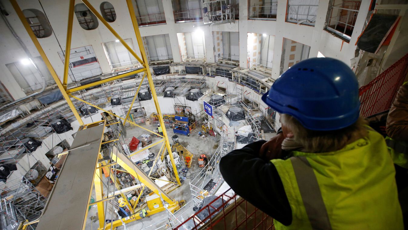 A technician looks at the circular bioshield inside the construction site of the International Thermonuclear Experimental Reactor (ITER) in Saint-Paul-lez-Durance