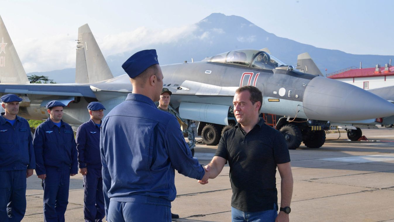 Russian Prime Minister Dmitry Medvedev shakes hands with Air Force officer at the Yasny airport during visits the Southern Kuril Island of Iturup