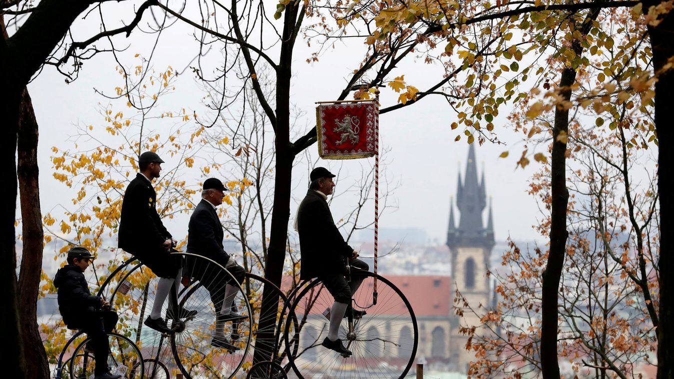 Participants wearing historical costumes ride their high-wheel bicycles during the annual penny farthing race in Prague