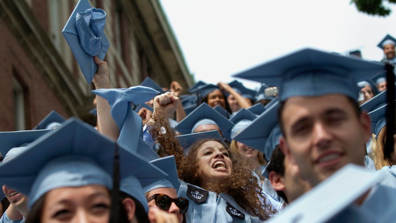 Graduates from Columbia University's School of Journalism cheer during the university's commencement ceremony in New York