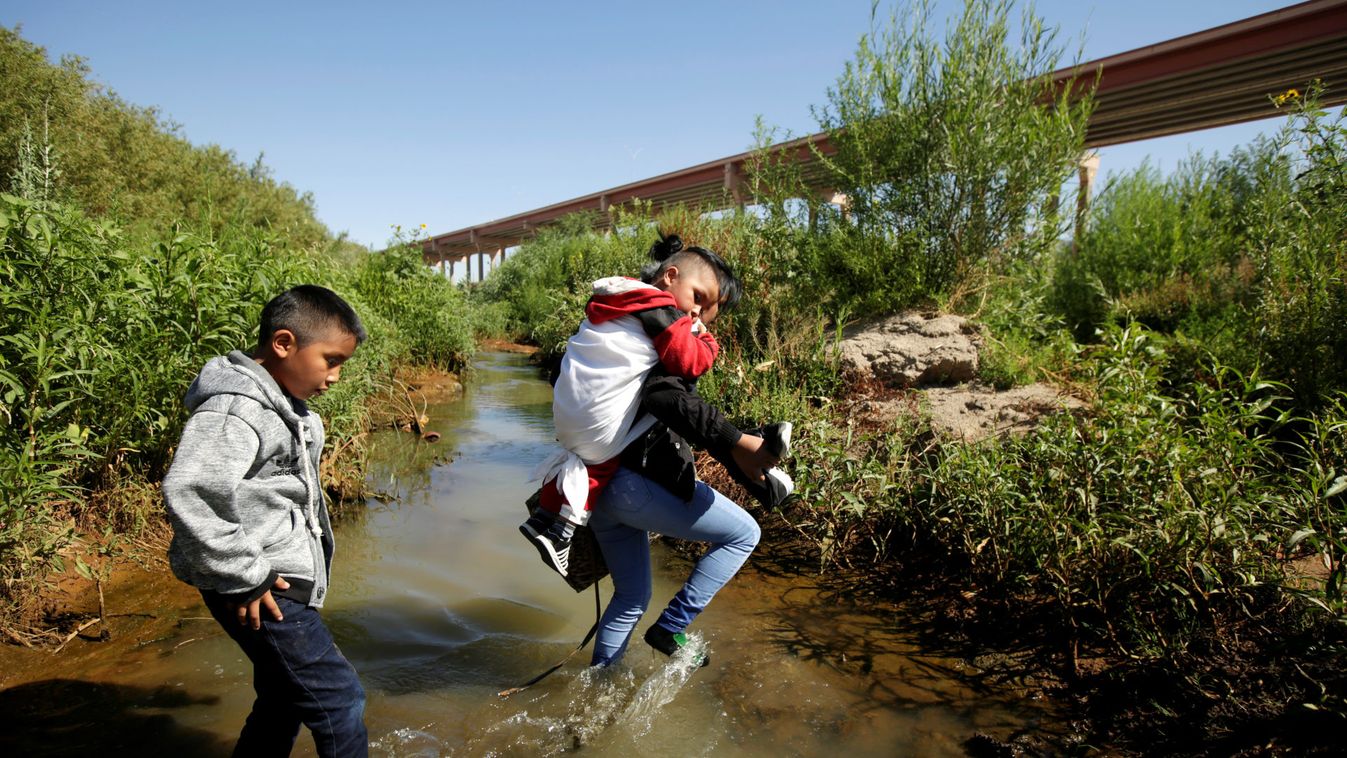 Migrants from Guatemala are seen on the banks of the Rio Bravo river as they cross illegally into the United States to turn themselves in to request asylum in El Paso, Texas, as seen from Ciudad Juarez