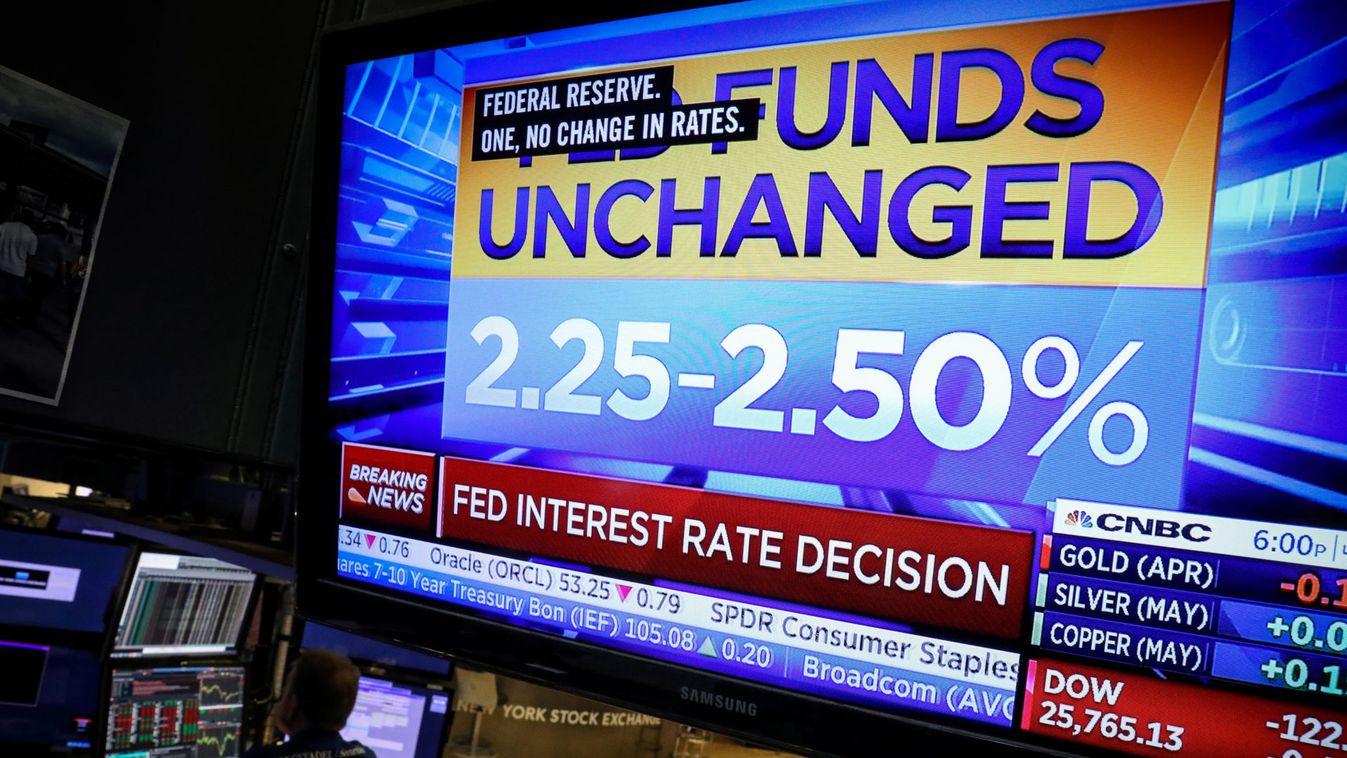 A screen shows the Fed rate announcement on the floor at the  NYSE in New York