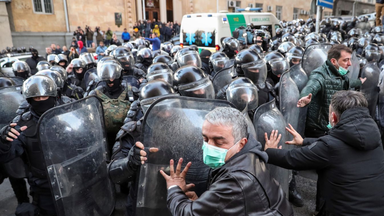 Riot police clash with demonstrators during a protest against the government and to demand an early parliamentary election in Tbilisi