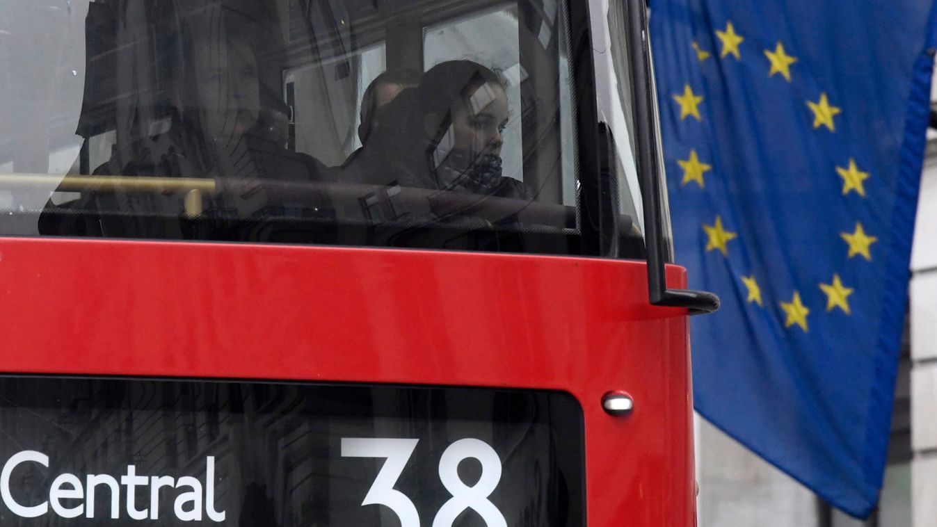 Passengers look out from a London bus as it passes an European Union flag on Piccadilly in London, Britain