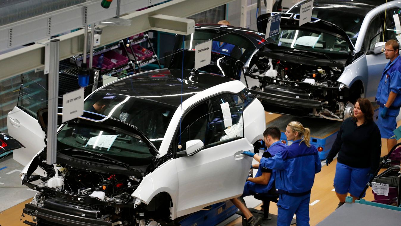 Workers assemble BMW i3 electric cars at the production line of the BMW factory in Leipzig